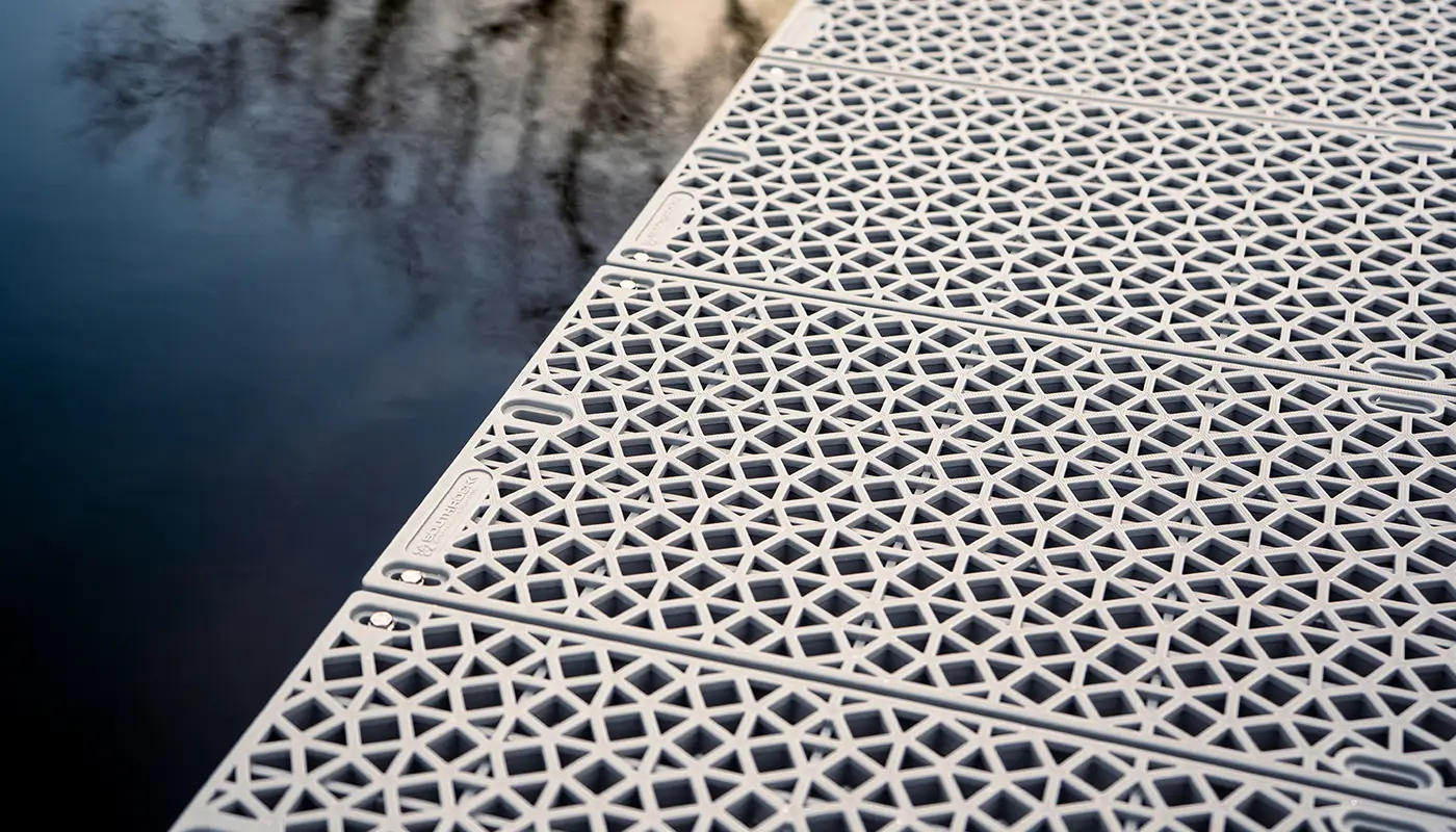 Photograph of plastic overlay on dock at a lake.